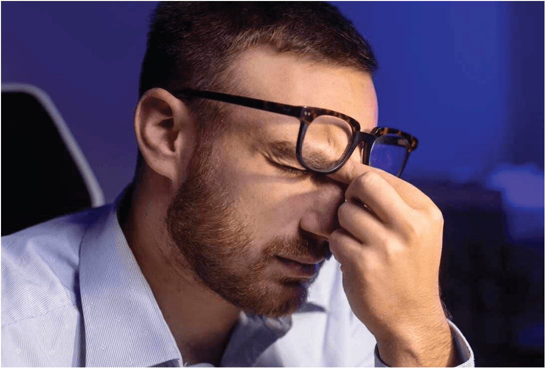Man experiencing eye strain during prolonged near work