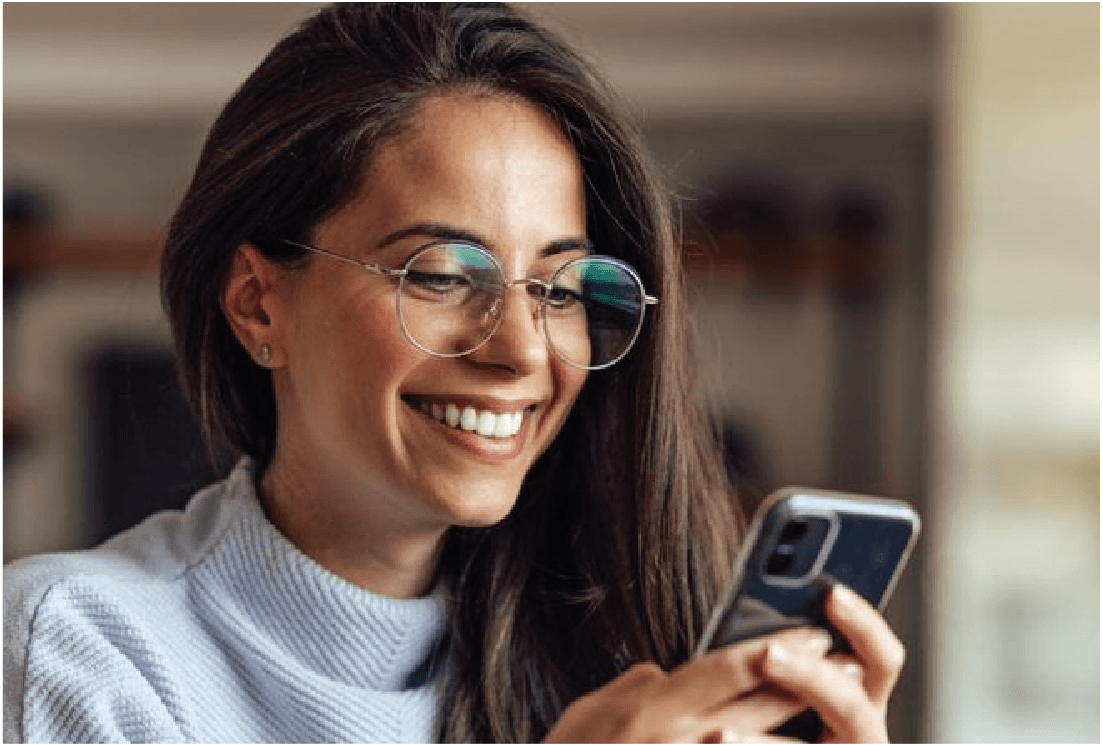 Woman comfortably using a phone while wearing glasses