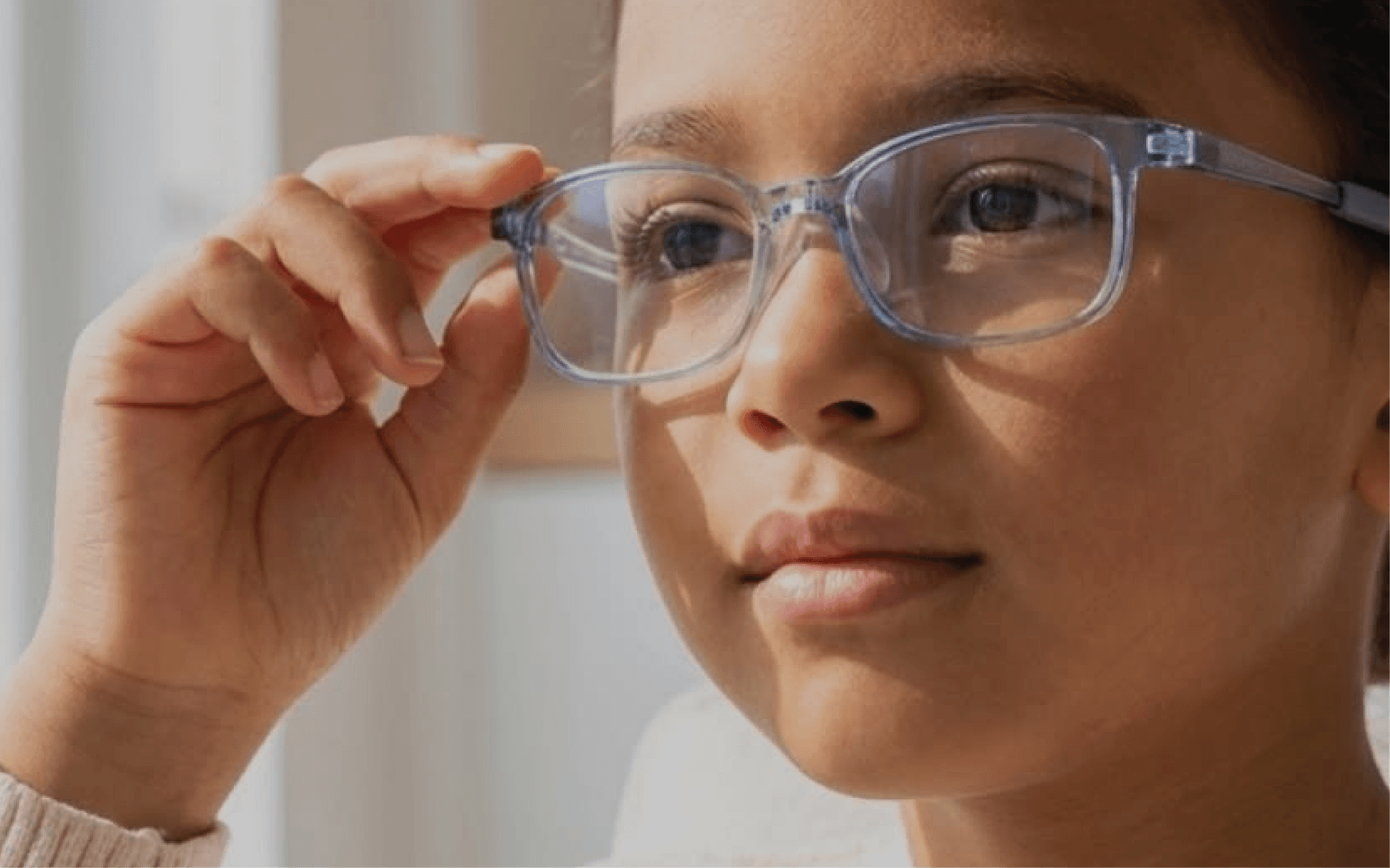 Child adjusting glasses for comfortable everyday vision